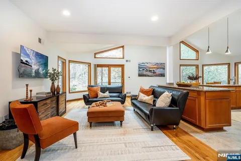 a large kitchen with kitchen island granite countertop a large counter top stainless steel appliances and cabinets