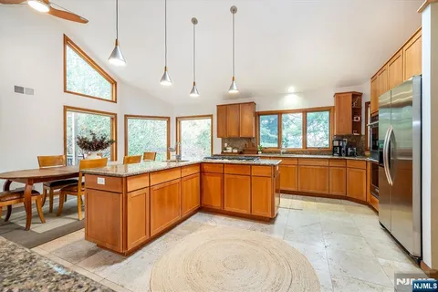 a kitchen with stainless steel appliances granite countertop a stove oven and a refrigerator