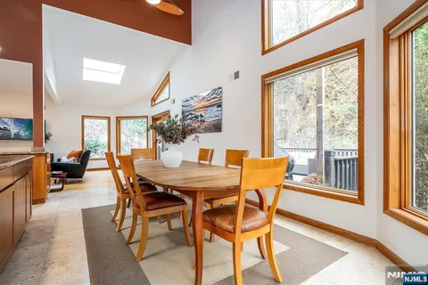 a view of a dining room with furniture a chandelier and wooden floor