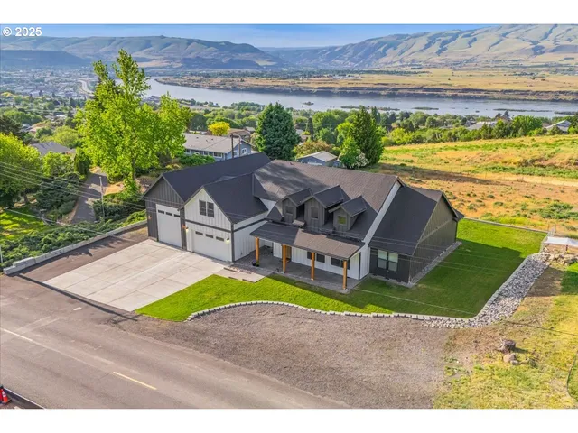 an aerial view of residential houses with outdoor space and ocean view