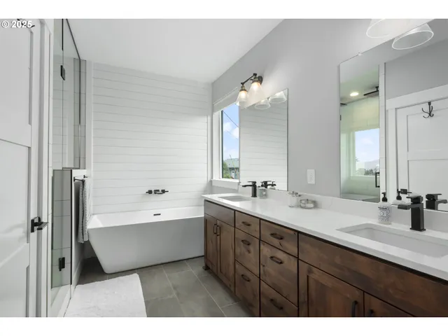 a view of a bedroom with wooden floor