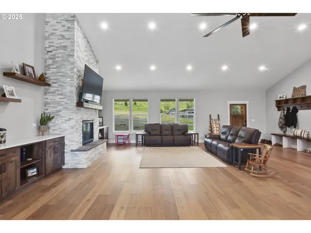 a living room with furniture a fireplace and a flat screen tv