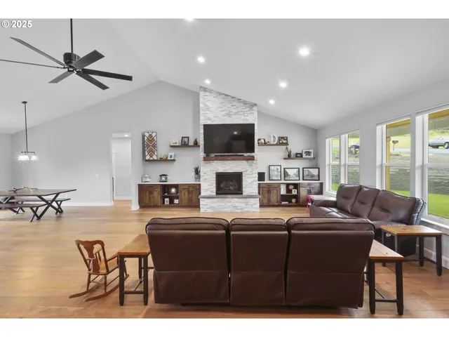 a living room with furniture a flat screen tv and a fireplace