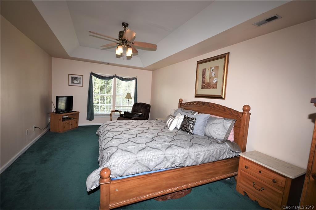 255 Choate Avenue Fort Mill, SC 29708 - Photo 26 of 38 a bedroom with a bed chandelier and a window