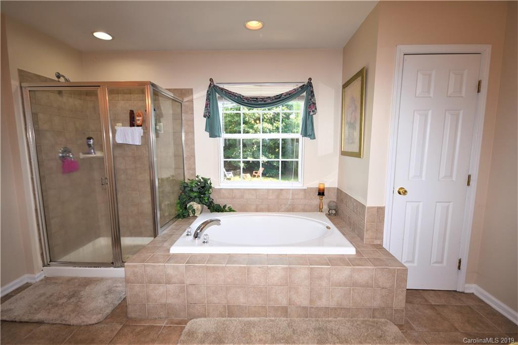255 Choate Avenue Fort Mill, SC 29708 - Photo 28 of 38 a bath tub sitting in a bathroom next to a window