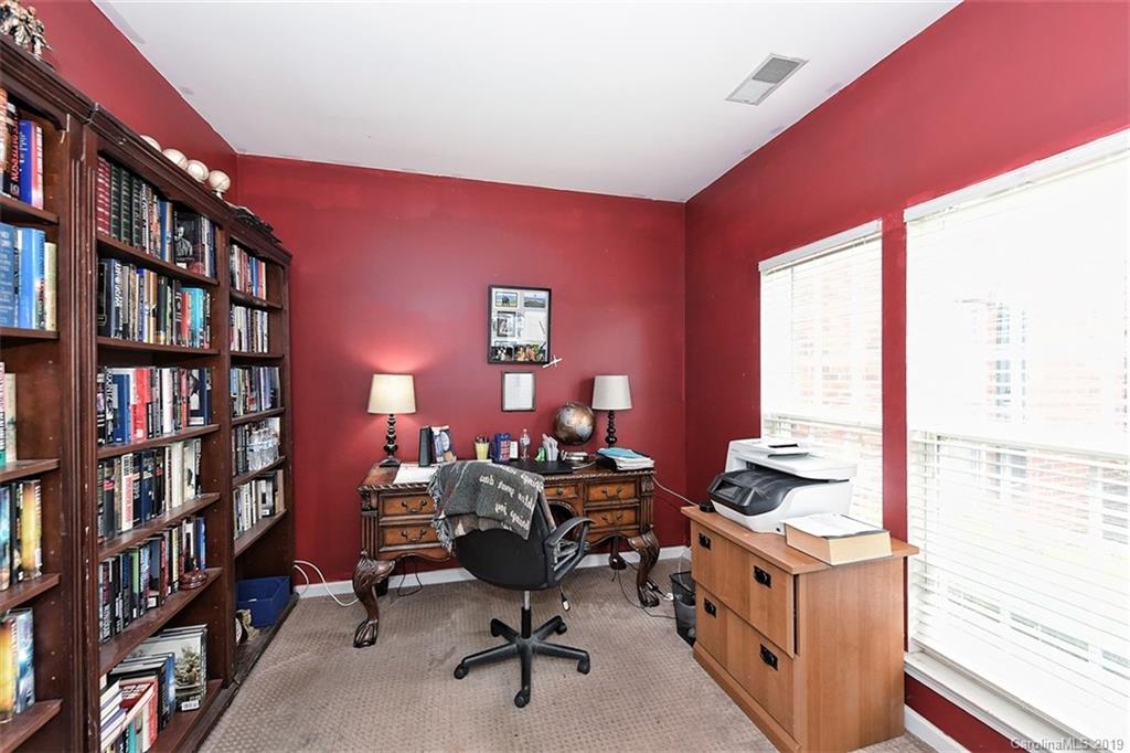 255 Choate Avenue Fort Mill, SC 29708 - Photo 4 of 38 a view of a workspace with furniture and a bookshelf