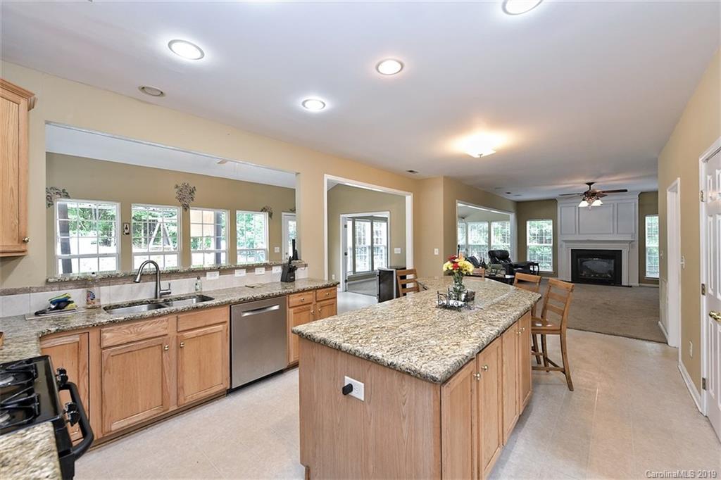 255 Choate Avenue Fort Mill, SC 29708 - Photo 7 of 38 a kitchen with granite countertop kitchen island sink stove and living room