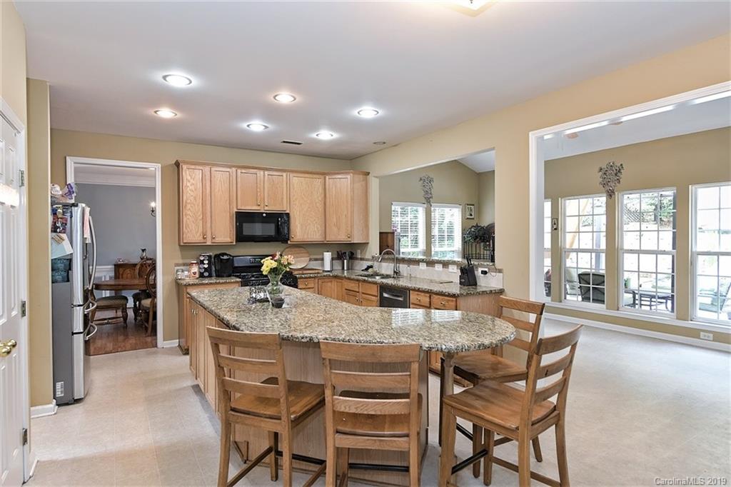 255 Choate Avenue Fort Mill, SC 29708 - Photo 9 of 38 a dining hall with stainless steel appliances granite countertop dining table chairs and view living room