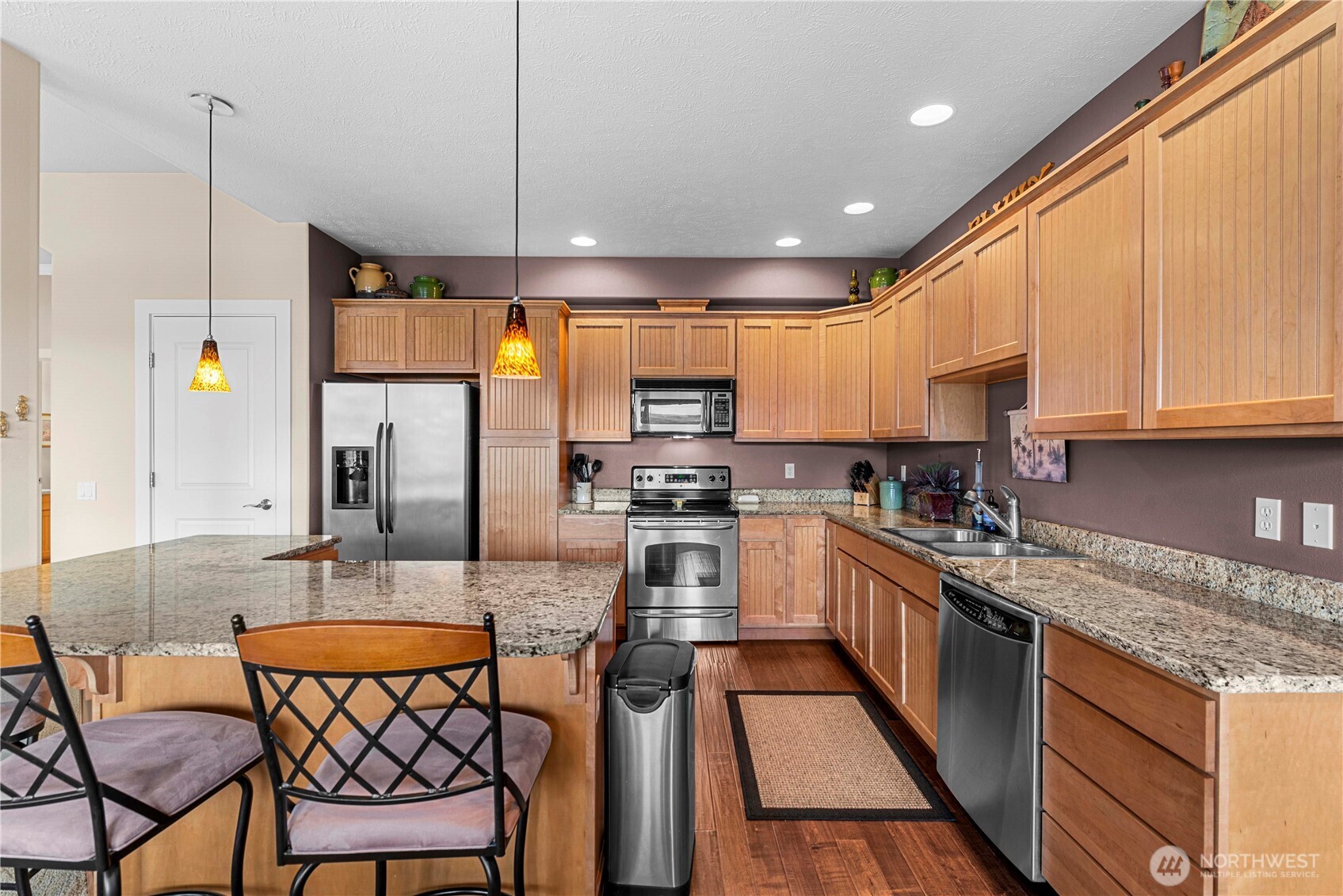 9122 Red Hawk Lane Northwest, Unit A76 Quincy, WA 98848 - Photo 11 of 40 a kitchen with stainless steel appliances granite countertop a sink a stove a refrigerator cabinets and chairs