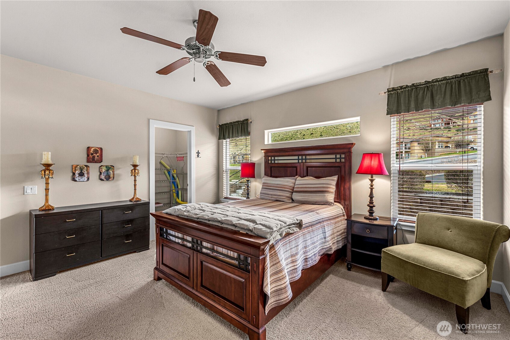 9122 Red Hawk Lane Northwest, Unit A76 Quincy, WA 98848 - Photo 19 of 40 a bedroom with a bed a dresser and a window