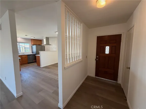a view of a hallway and a livingroom with furniture