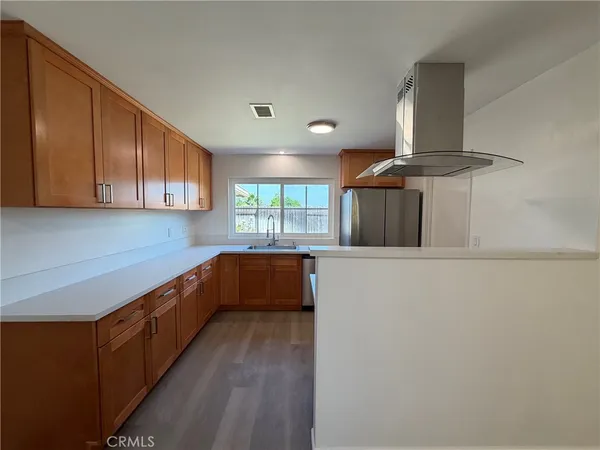 a kitchen with stainless steel appliances a refrigerator and a stove top oven