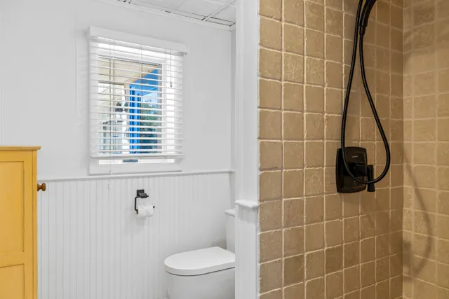 a bathroom with a toilet a sink and a shower