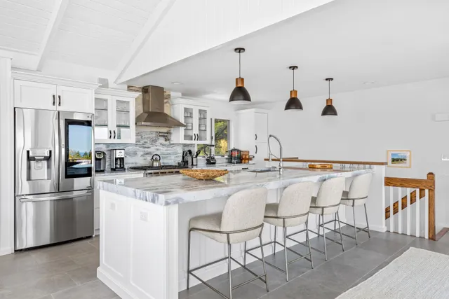 a kitchen with stainless steel appliances kitchen island granite countertop a sink and cabinets