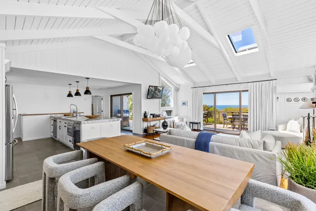 a living room with furniture a table and chairs