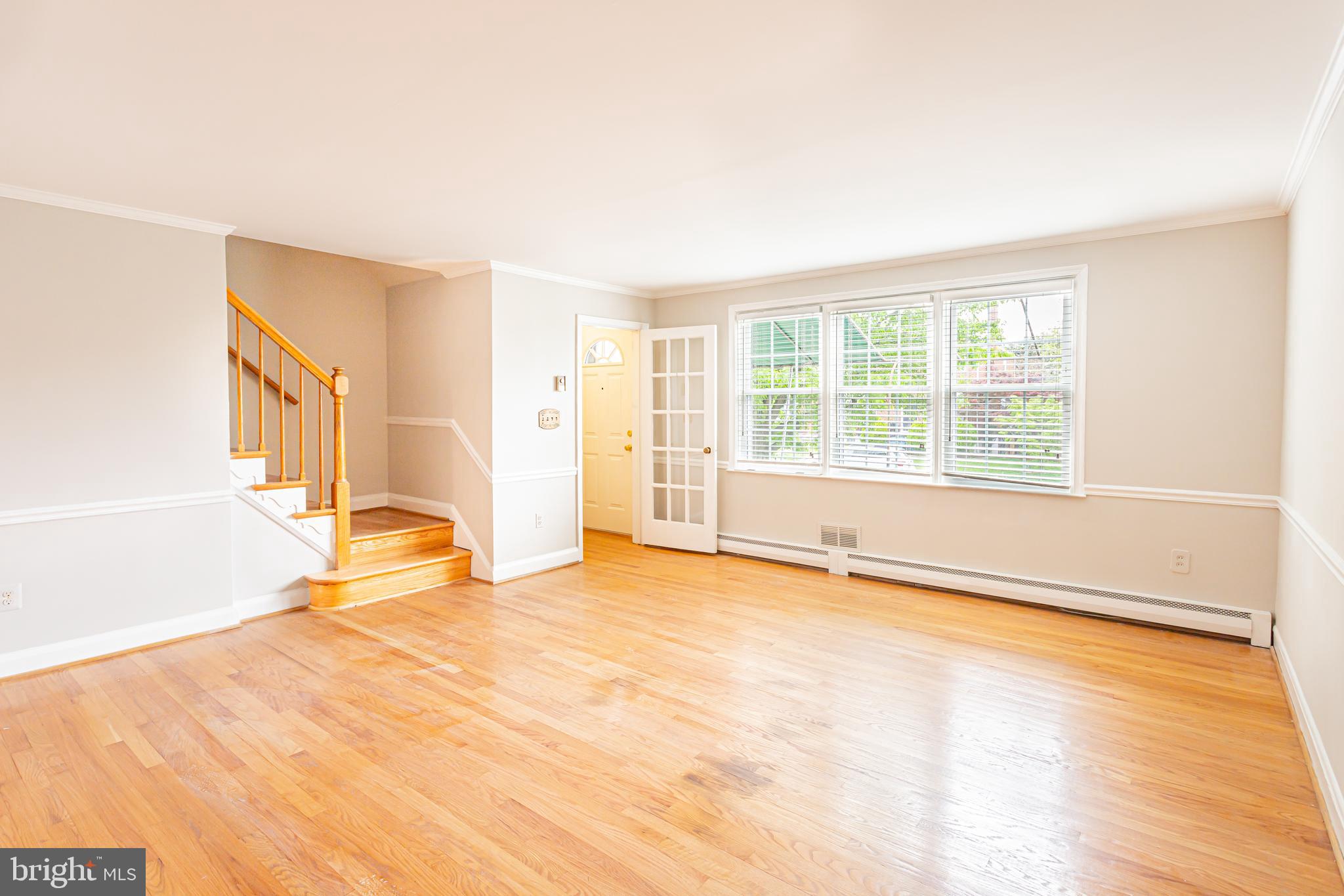 8426 Pleasant Plains Road Towson, MD 21286 - Photo 3 of 25 a view of an empty room with wooden floor and a window