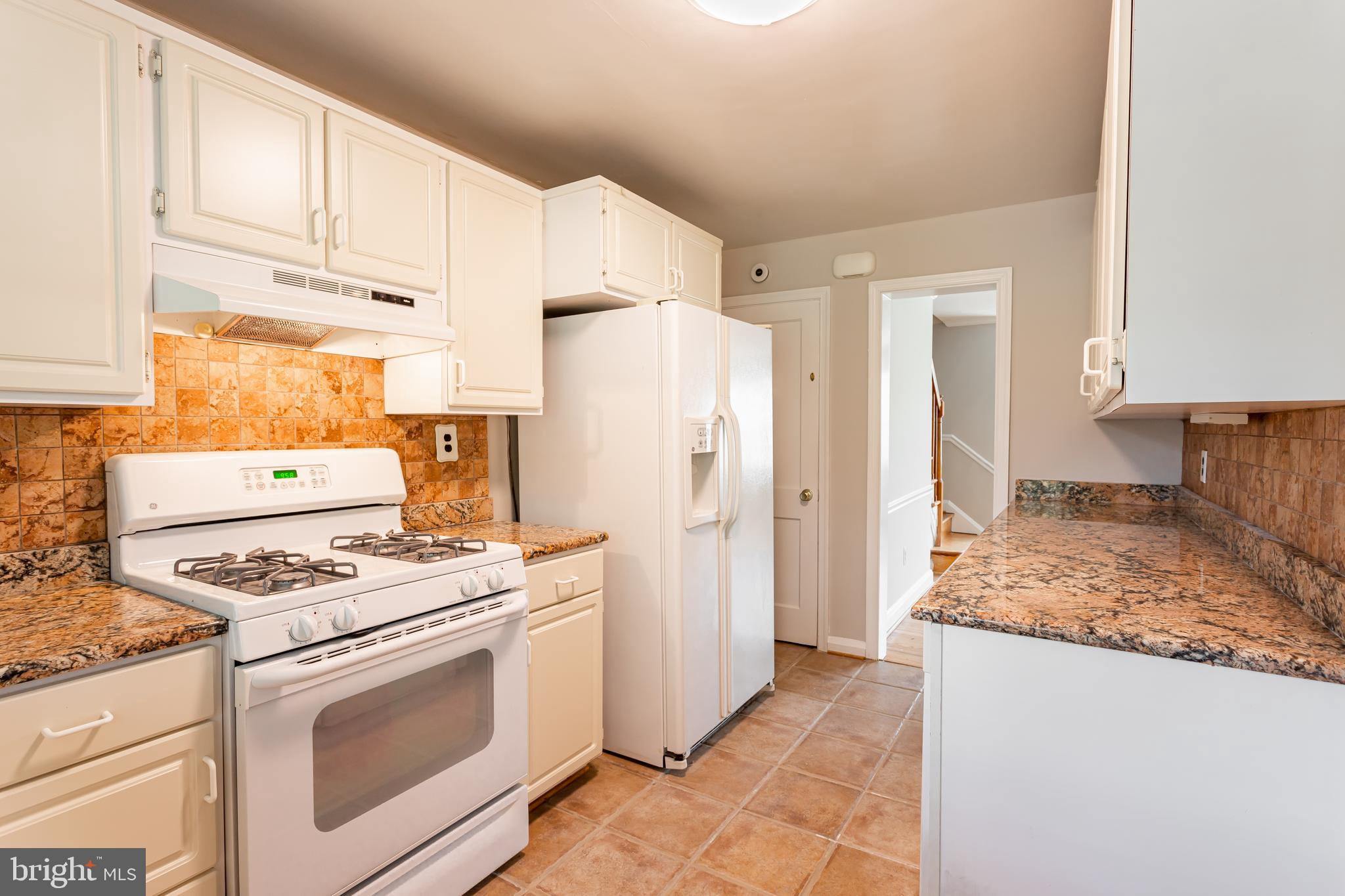 8426 Pleasant Plains Road Towson, MD 21286 - Photo 7 of 25 a kitchen with granite countertop cabinets and refrigerator stove