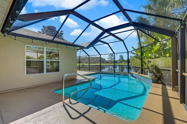 a front view of a house with a garden and yard