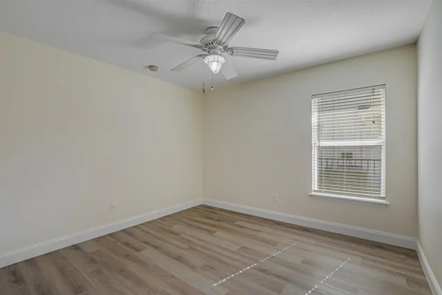 a view of an empty room and wooden floor