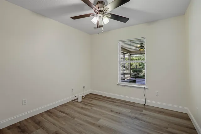 wooden floor in an empty room with a window