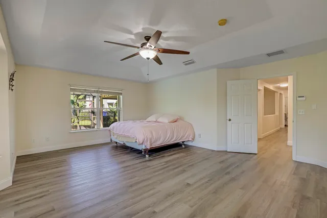 a bedroom with a large bed and a large window