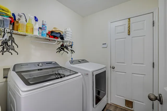 a view of a backyard with table and chairs under an umbrella