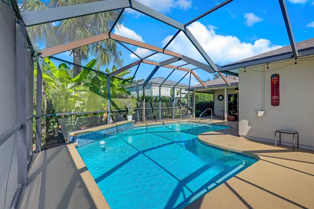 a view of a backyard with a swimming pool