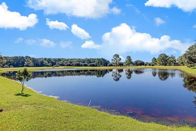 a view of a backyard with a sitting area and a garden