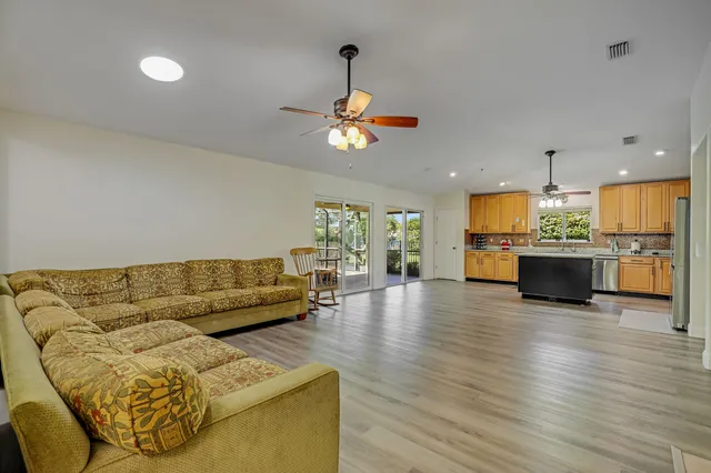 a kitchen with a sink cabinets and wooden floor