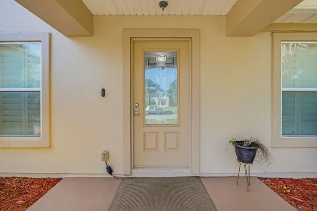 an empty room with wooden floor and mirror