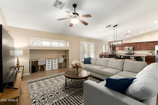 a living room with furniture and a chandelier