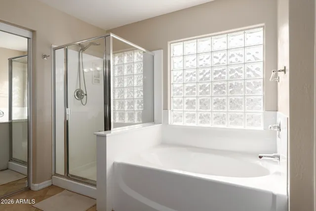 a view of walk in closet with clothes