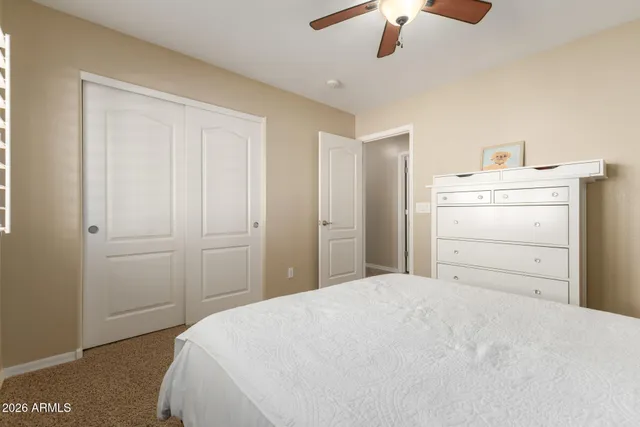 a view of backyard with a table and chairs under an umbrella