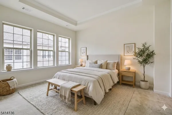 a bedroom with a bed and a potted plant