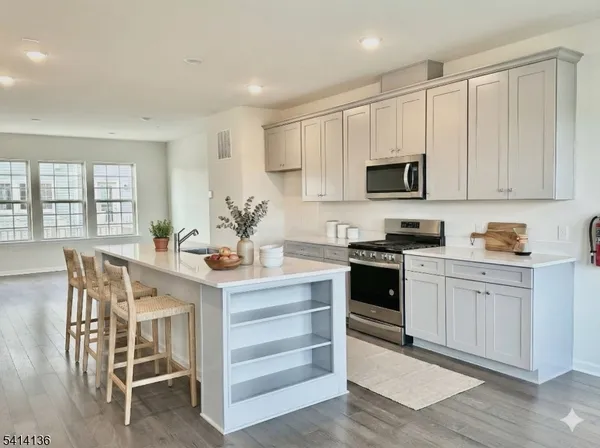 a kitchen with a stove a sink and a microwave