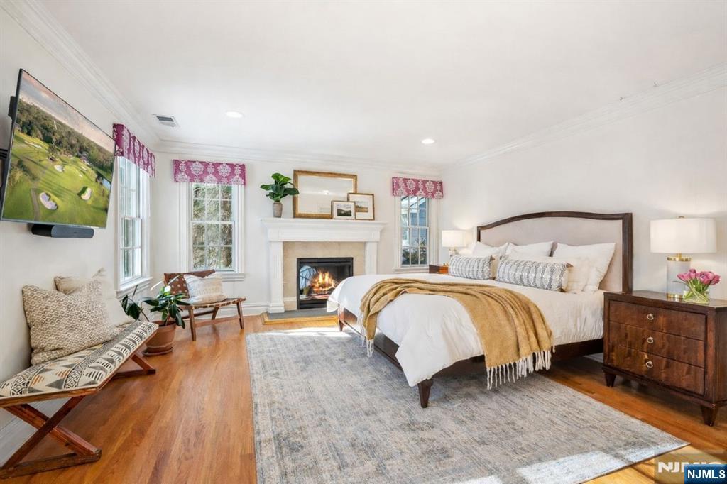 9 Mt Vernon Road Montclair, NJ 07043 - Photo 19 of 46 a spacious bedroom with a bed and a fireplace