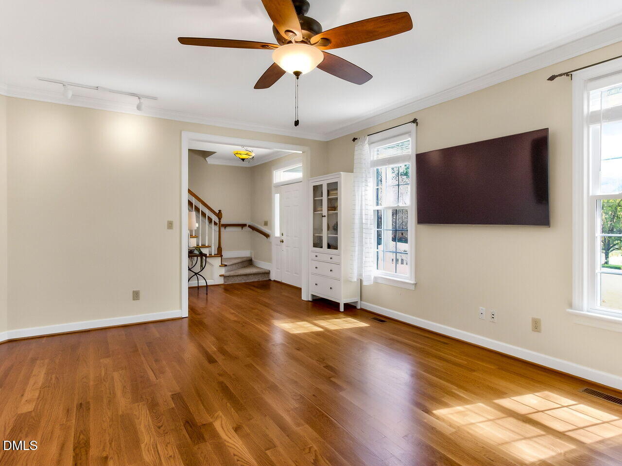 6104 Wolverhampton Drive Raleigh, NC 27603 - Photo 3 of 35 a view of a livingroom with wooden floor and a ceiling fan