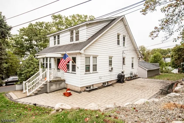 a view of a house with snow on the road
