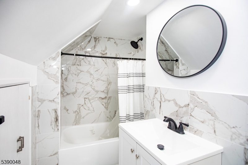 20 Summit Avenue, Unit 2 Hawthorne, NJ 07506 - Photo 12 of 24 a bathroom with a sink and a mirror