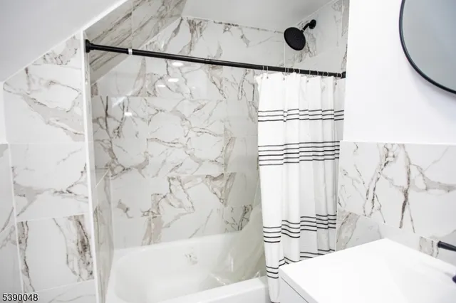 a bathroom with a bathtub and shower