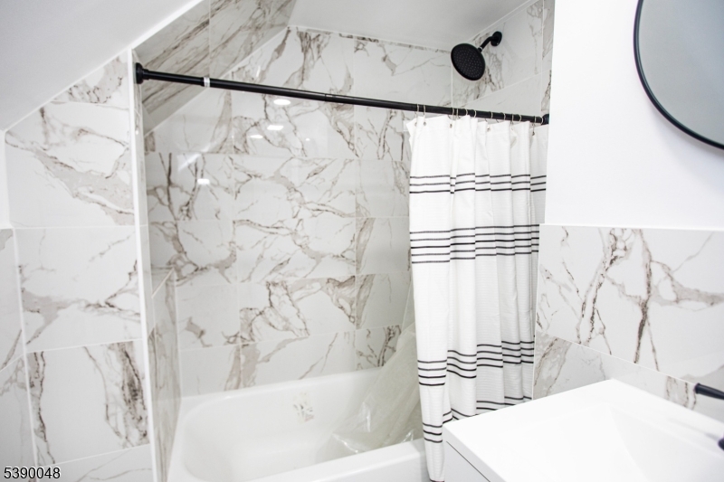 20 Summit Avenue, Unit 2 Hawthorne, NJ 07506 - Photo 13 of 24 a bathroom with a bathtub and shower