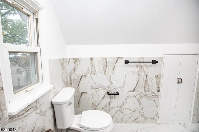 a white toilet sitting next to a bathroom sink