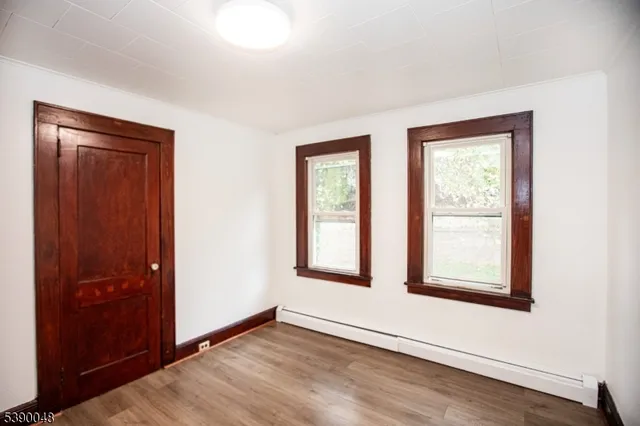 an empty room with windows and closet