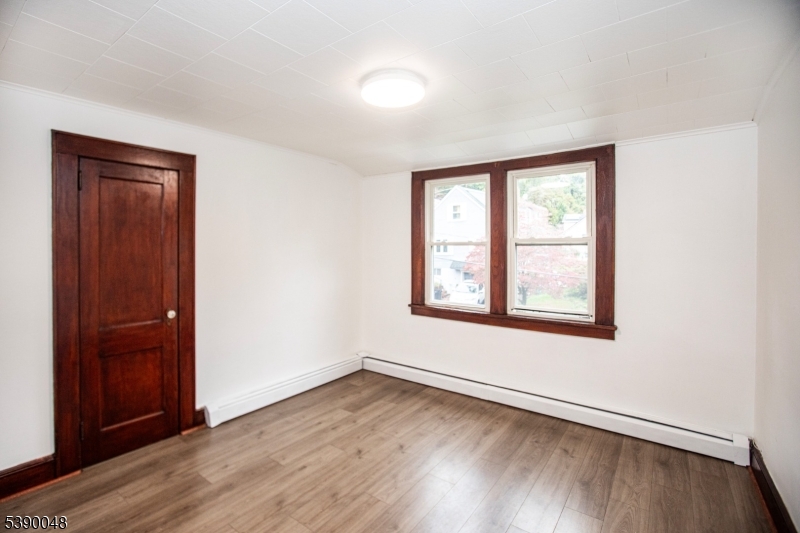 20 Summit Avenue, Unit 2 Hawthorne, NJ 07506 - Photo 20 of 24 an empty room with wooden floor and windows