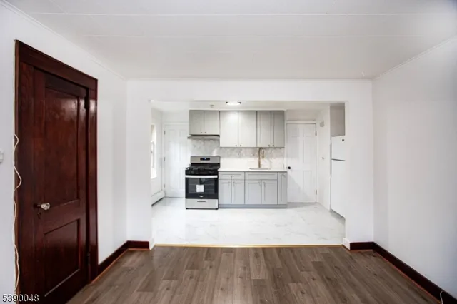 a kitchen with wooden floors and white appliances