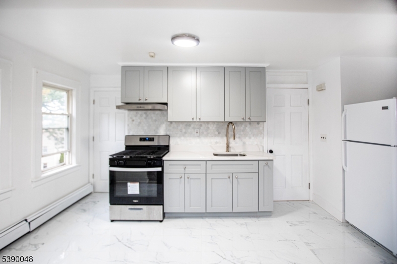 20 Summit Avenue, Unit 2 Hawthorne, NJ 07506 - Photo 6 of 24 a kitchen with stainless steel appliances granite countertop a stove a refrigerator and a refrigerator