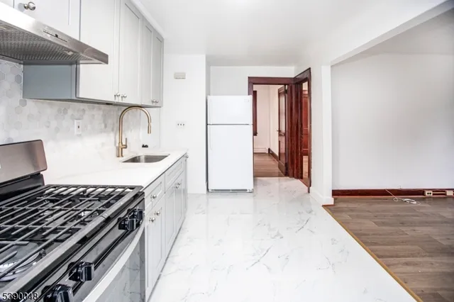 a kitchen with a stove and a refrigerator
