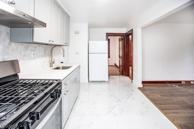 20 Summit Avenue, Unit 2 Hawthorne, NJ 07506 - Photo 8 of 24 a kitchen with a stove and a refrigerator