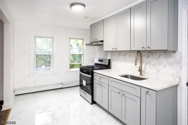 a kitchen with a sink window and cabinets