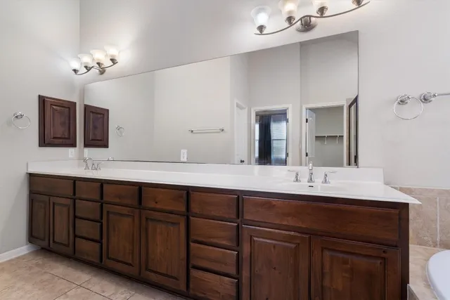 a bathroom with a double vanity sink and a mirror